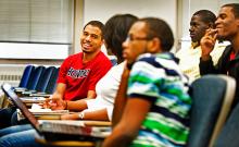 Students sitting in class talking at Howard University 