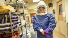woman putting on Personal Protective Equipment (PPE)